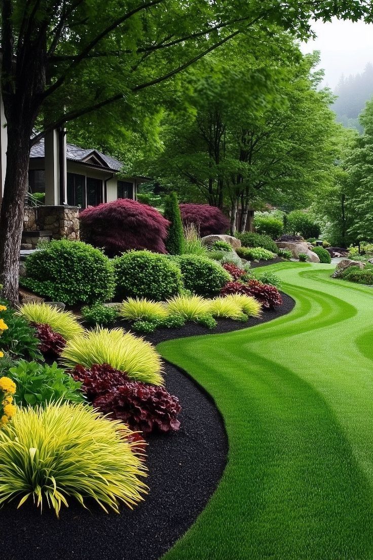 Beautifully redesigned garden border with roses and lush planting